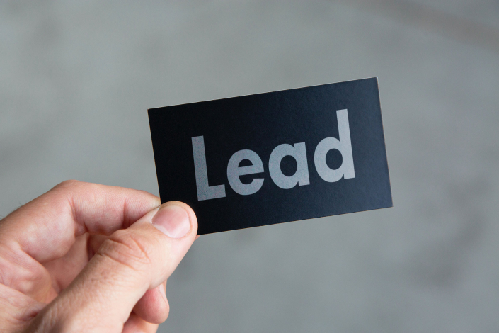 Black Business Card with the Word Lead on it
